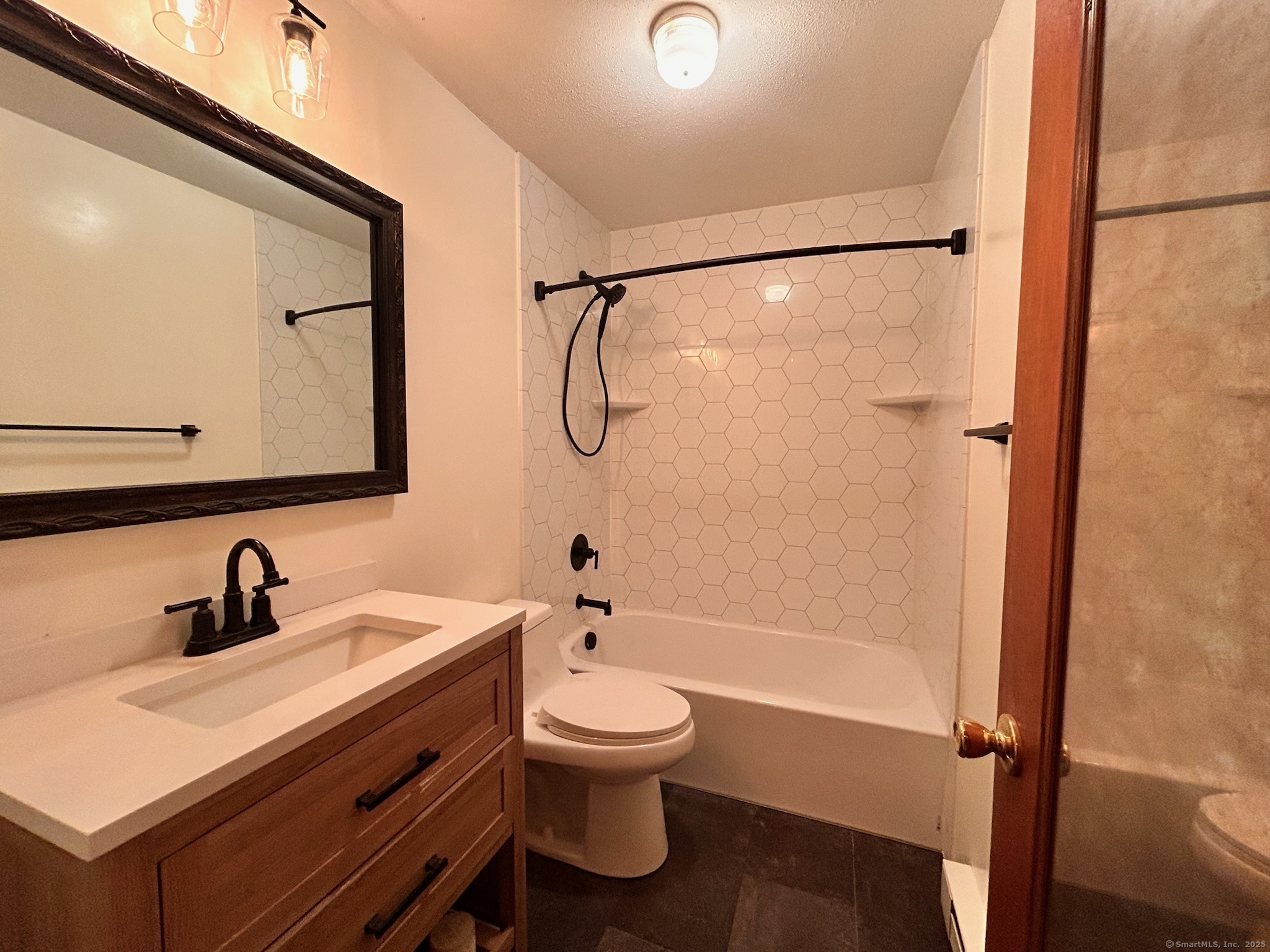 213 Baxter Road, Unit B Storrs Mansfield, CT 06268 - Photo 10 of 12 a bathroom with a sink a toilet and a mirror
