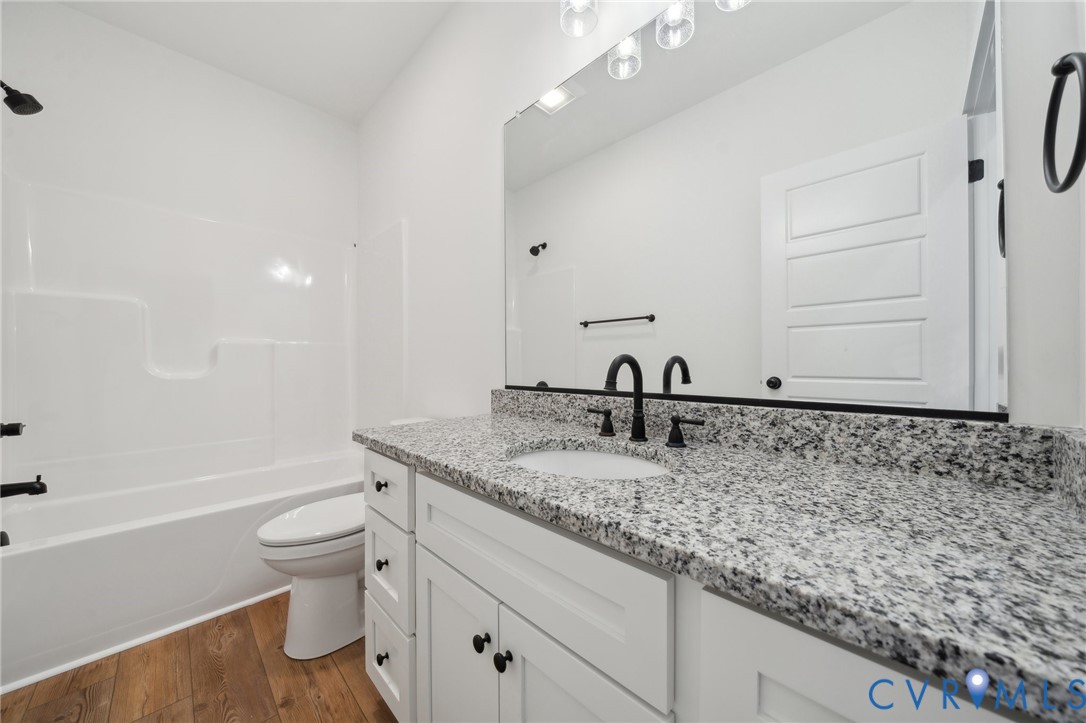 2305 Halls Store Road Mineral, VA 23117 - Photo 19 of 26 a bathroom with a granite countertop sink toilet and shower