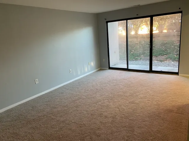 a view of an empty room with a large window