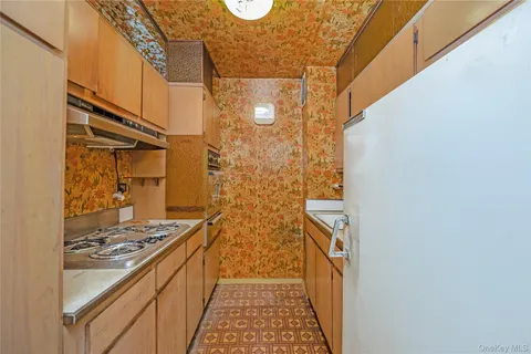 a bathroom with a granite countertop shower and a stove