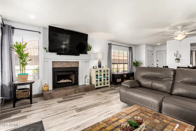 a living room with fireplace furniture and a flat screen tv