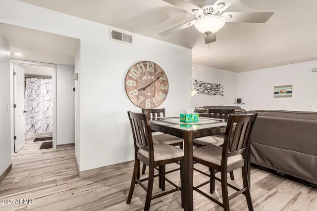 a dining room with furniture and wooden floor