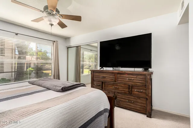 a bedroom with a bed and a flat screen tv