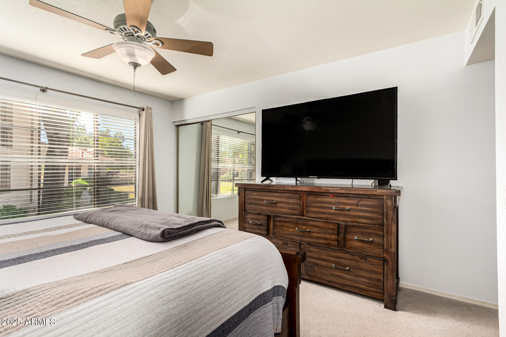 8700 East Mountain View Road, Unit 1014 Scottsdale, AZ 85258 - Photo 14 of 41 a bedroom with a bed and a flat screen tv