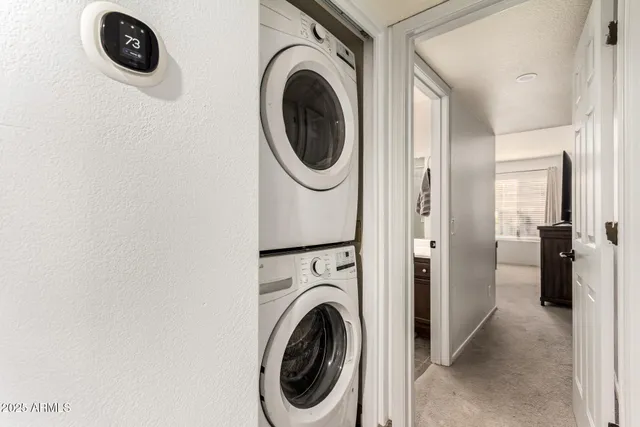 a view of a storage and utility room with washer and dryer