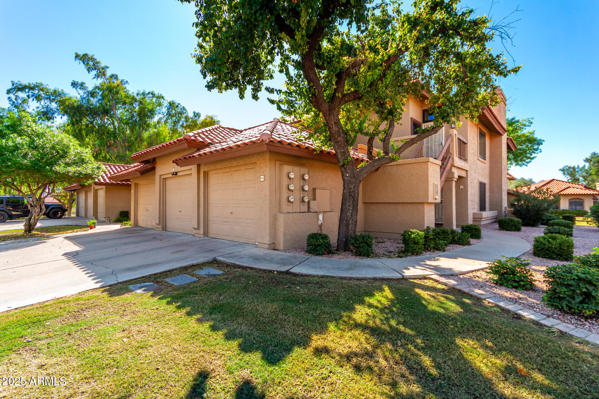 8700 East Mountain View Road, Unit 1014 Scottsdale, AZ 85258 - Photo 30 of 41 a front view of a house with a garden and yard