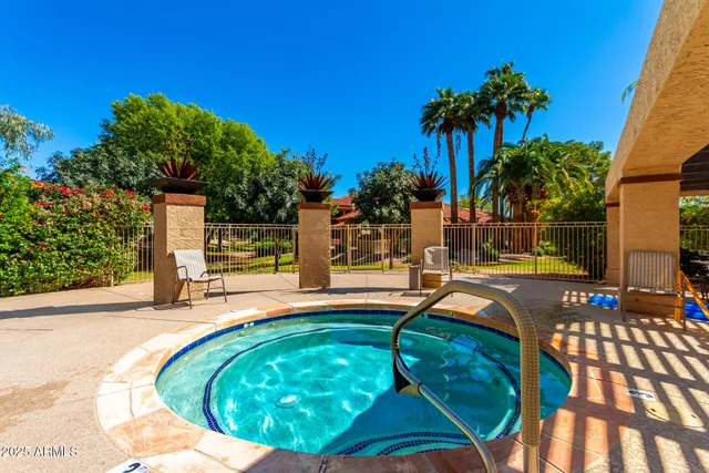 a swimming pool with outdoor seating yard and plants