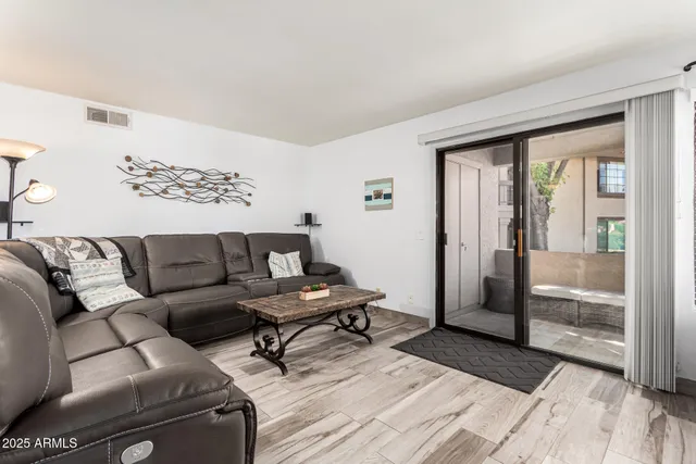 a living room with furniture and a floor to ceiling window
