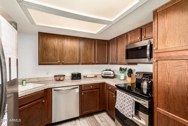 a kitchen with stainless steel appliances granite countertop a sink stove microwave and cabinets