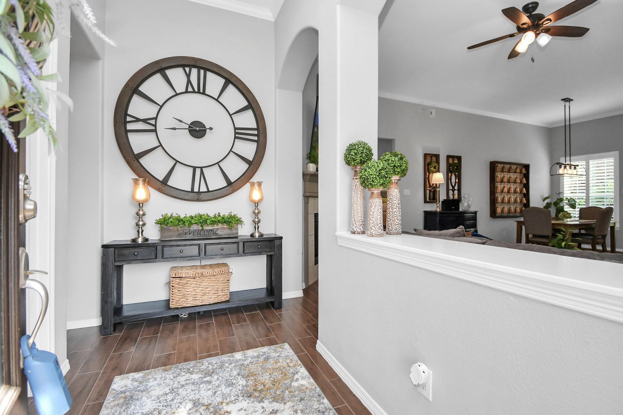 8624 Sunset Loch Drive Spring, TX 77379 - Photo 2 of 44 a view of a hallway with wooden floor and a chandelier