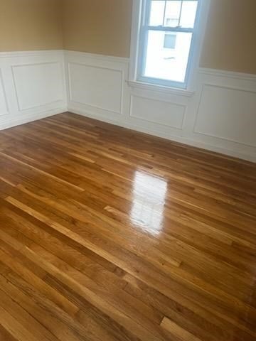 31 Badger Road Boston, MA 02136 - Photo 5 of 19 an empty room with wooden floor and windows