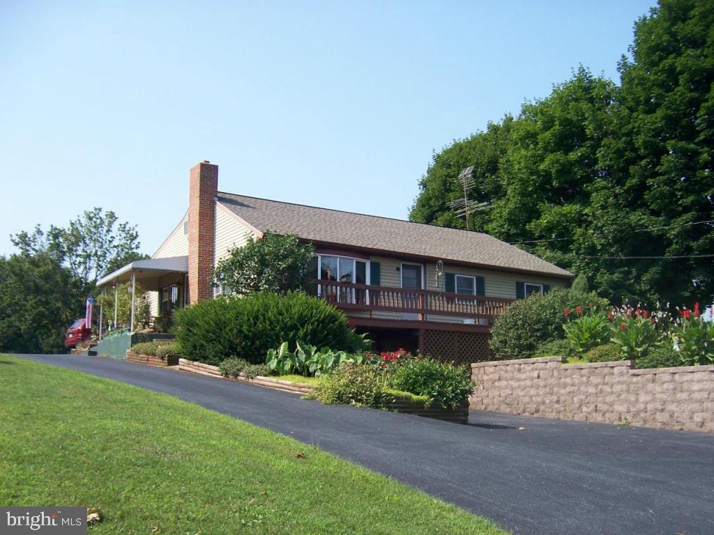 a front view of a house with a garden and plants