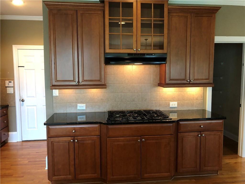 2575 Goodrick Lane Cumming, GA 30041 - Photo 13 of 30 a kitchen with granite countertop cabinets and window