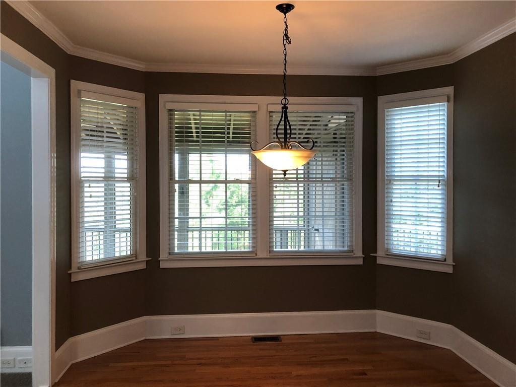 2575 Goodrick Lane Cumming, GA 30041 - Photo 14 of 30 a view of an empty room with wooden floor and a window