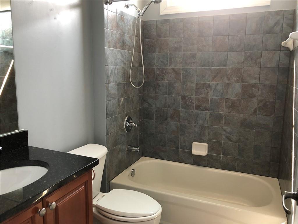 2575 Goodrick Lane Cumming, GA 30041 - Photo 18 of 30 a bathroom with a granite countertop bathtub shower sink mirror vanity and toilet