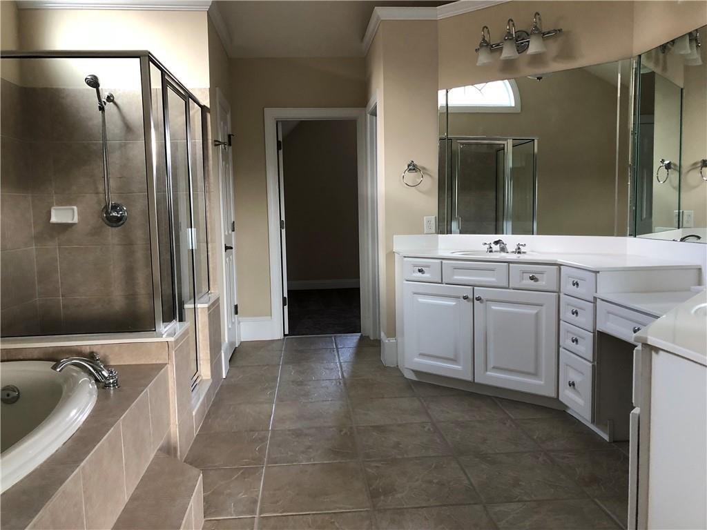 2575 Goodrick Lane Cumming, GA 30041 - Photo 23 of 30 a spacious bathroom with a tub sink shower and mirror