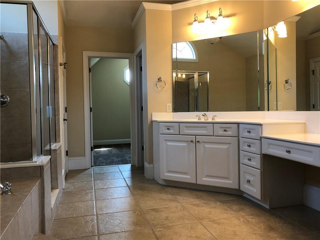 2575 Goodrick Lane Cumming, GA 30041 - Photo 25 of 30 a spacious bathroom with a granite countertop sink mirror and shower