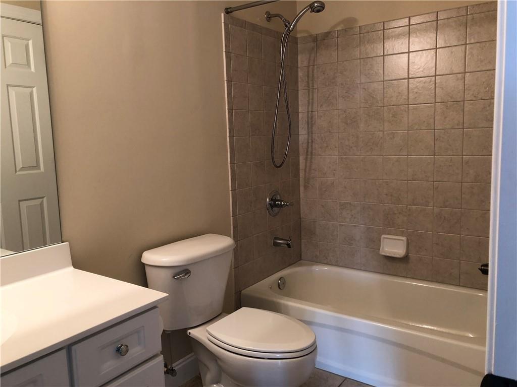 2575 Goodrick Lane Cumming, GA 30041 - Photo 27 of 30 a white toilet and tub sitting next to a bathroom sink