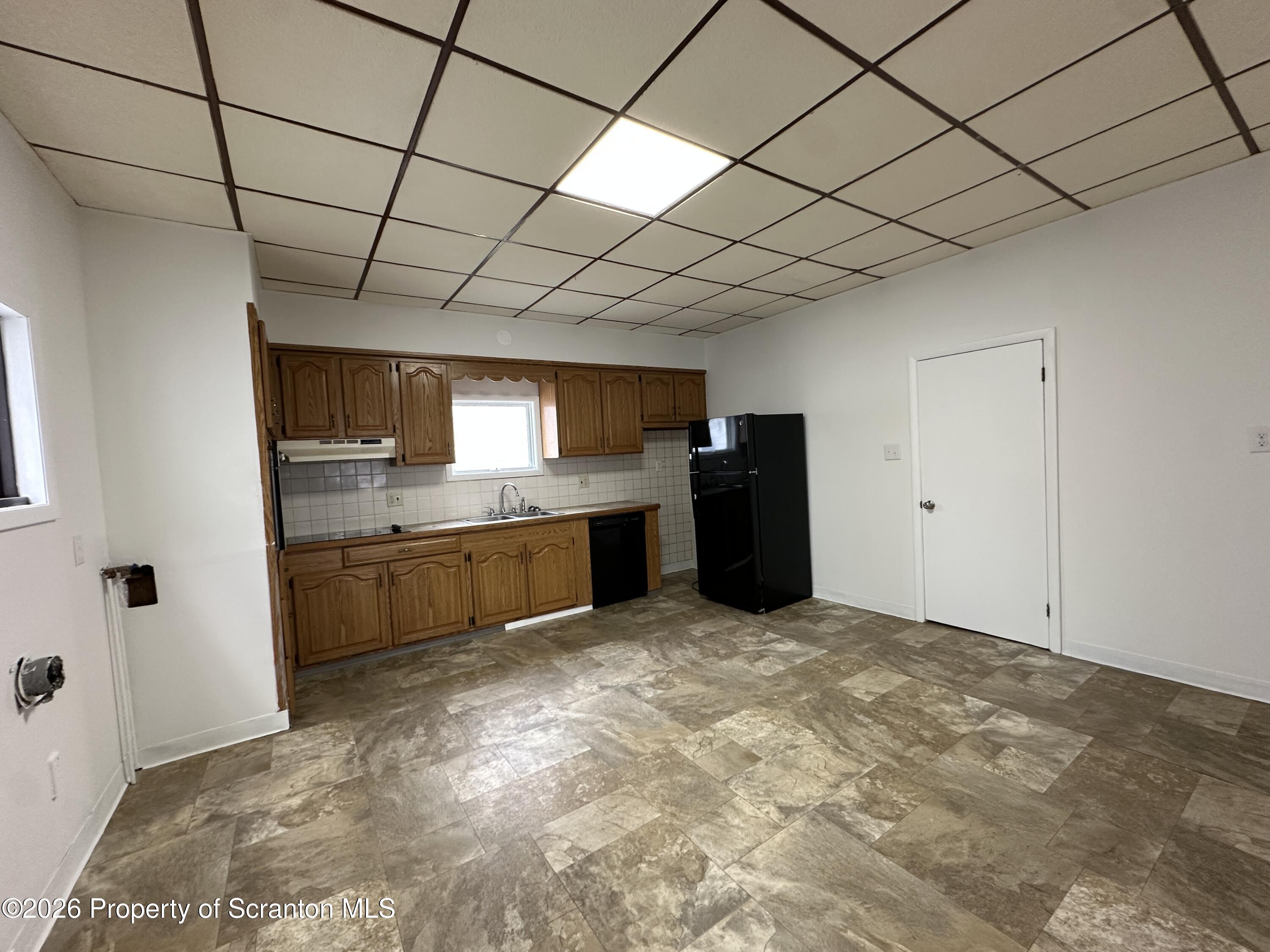 732 Main Street Avoca, PA 18641 - Photo 2 of 14 a large kitchen with a stove top oven a sink and cabinets