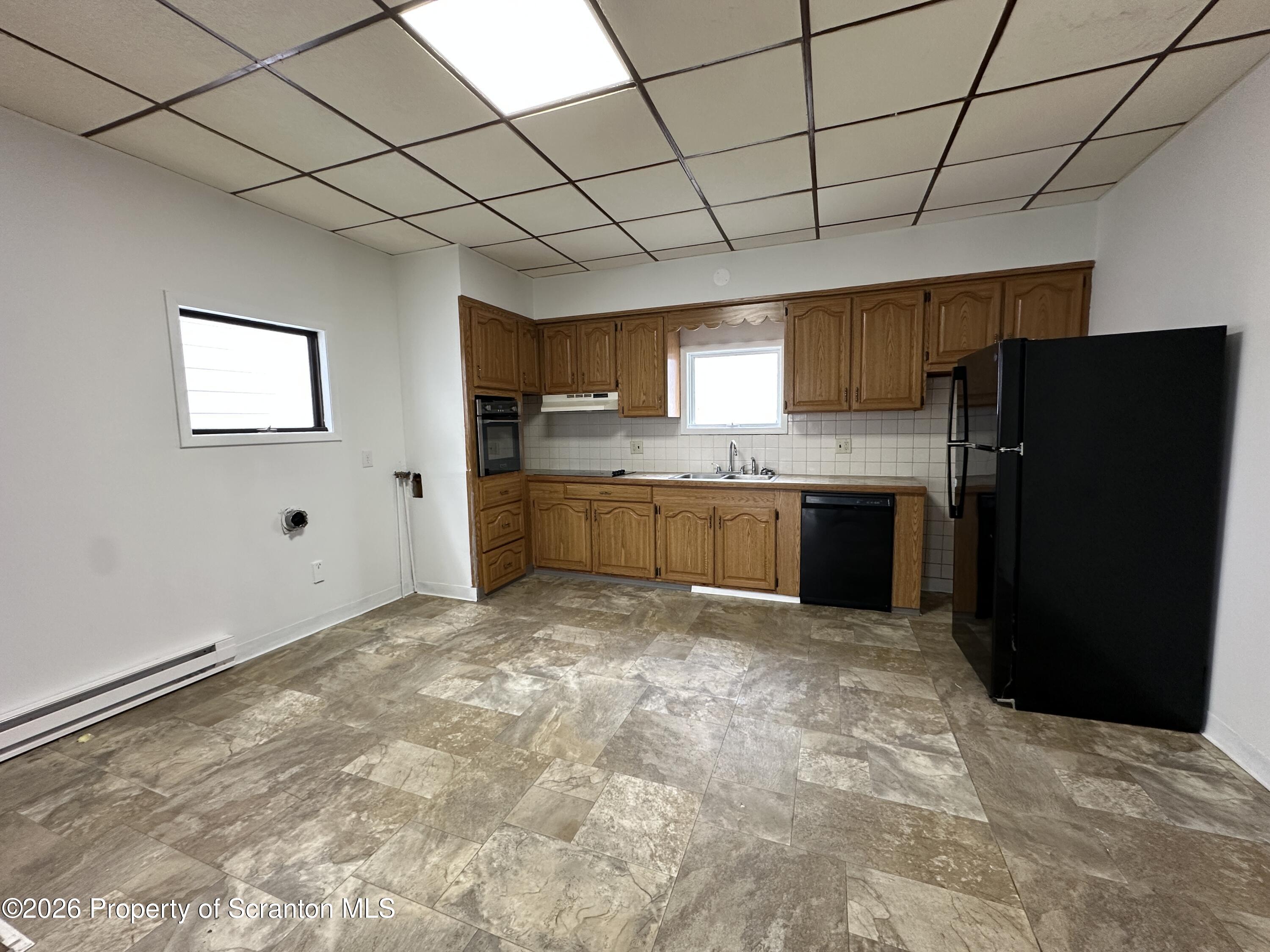 732 Main Street Avoca, PA 18641 - Photo 3 of 14 a kitchen with stainless steel appliances granite countertop a refrigerator and a sink
