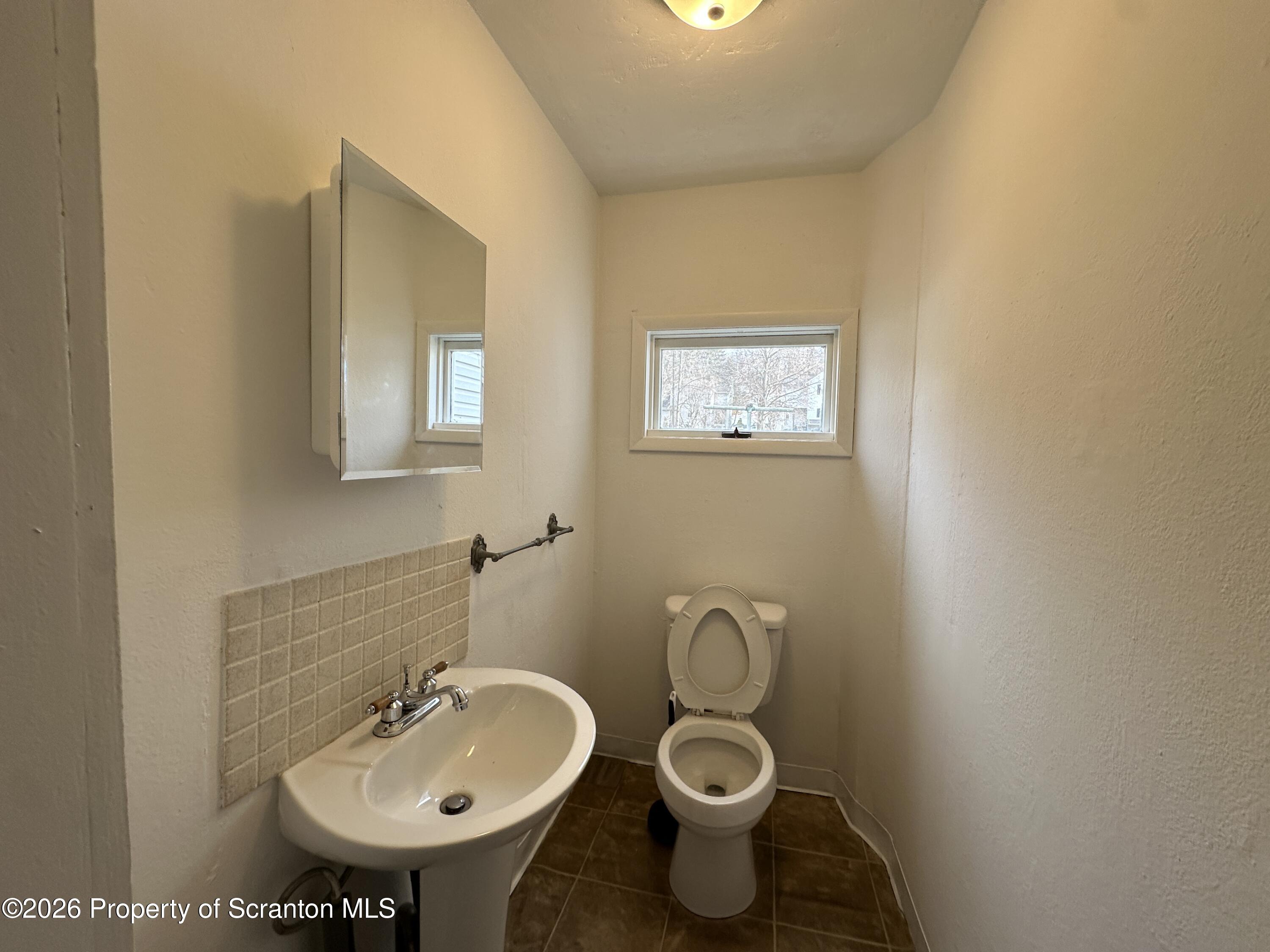732 Main Street Avoca, PA 18641 - Photo 4 of 14 a bathroom with a sink and a toilet