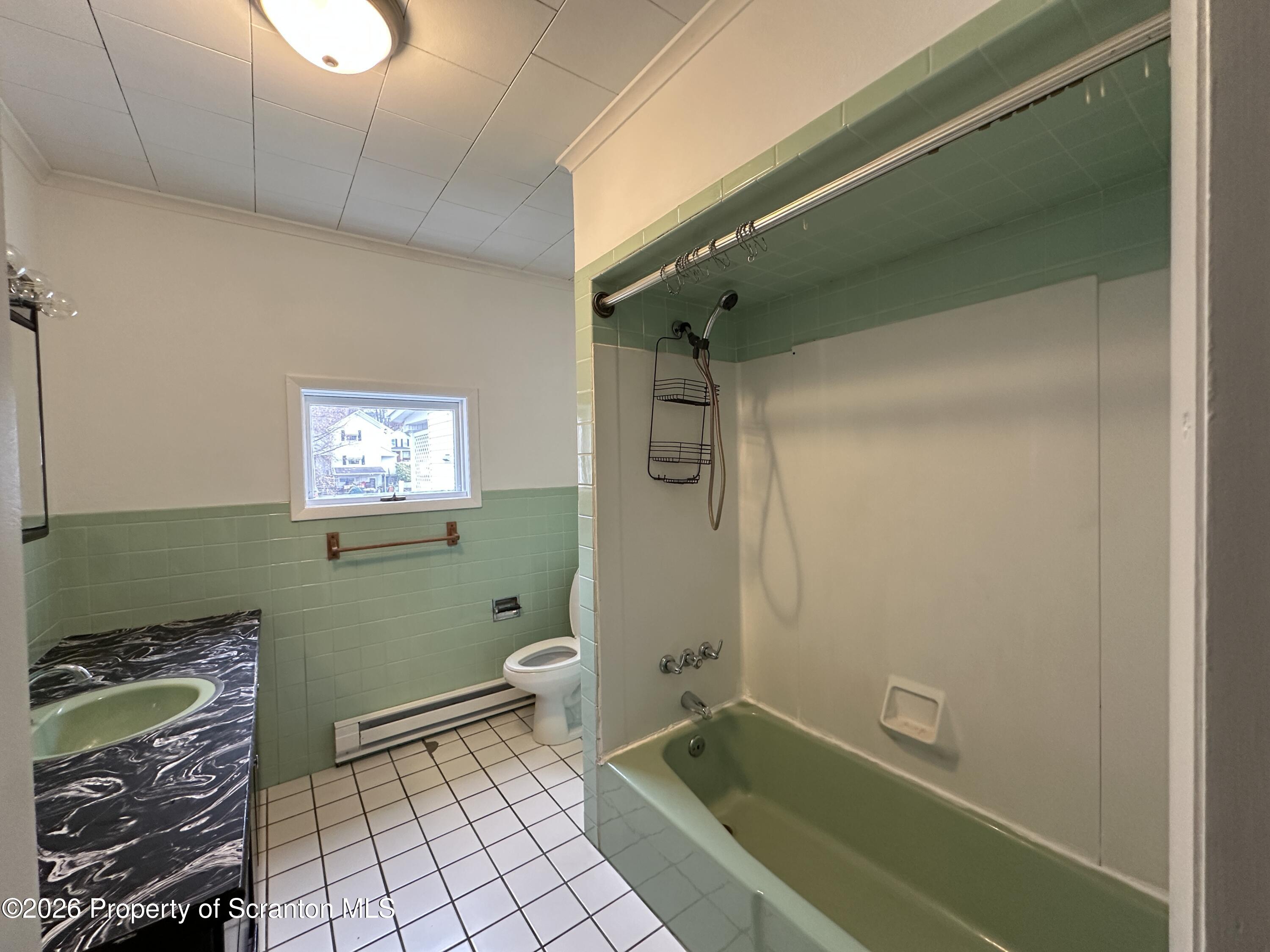 732 Main Street Avoca, PA 18641 - Photo 9 of 14 a bathroom with a sink a toilet and a shower