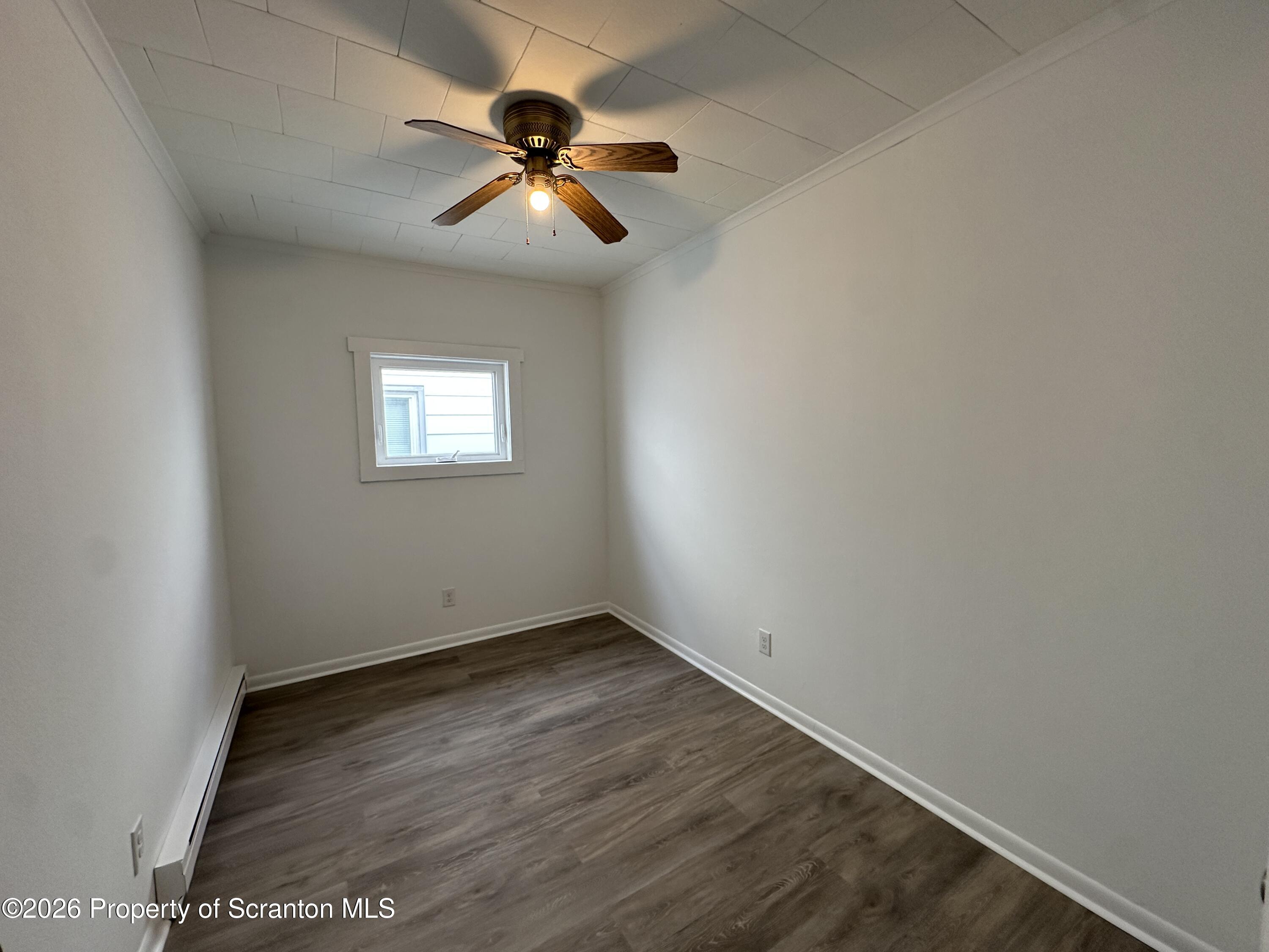 732 Main Street Avoca, PA 18641 - Photo 10 of 14 an empty room with windows and fan