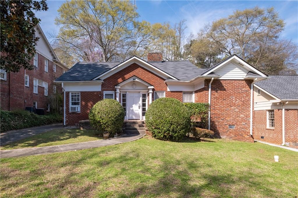 1384 Emory Road Northeast Atlanta, GA 30306 - Photo 1 of 1 a front view of a house with a yard