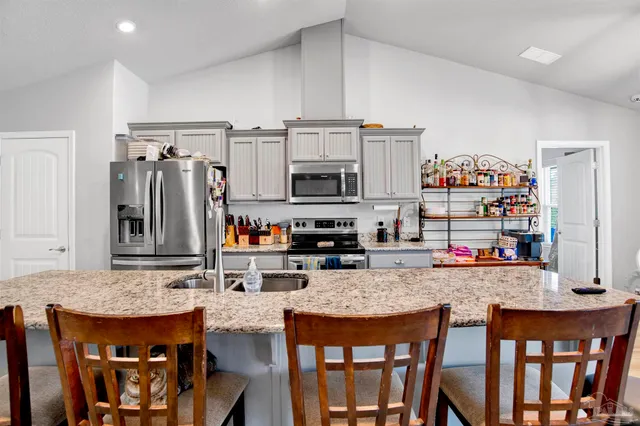 a bedroom with bed and wooden floor