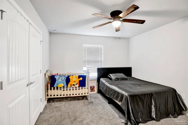 a bathroom with a granite countertop sink a toilet and a mirror