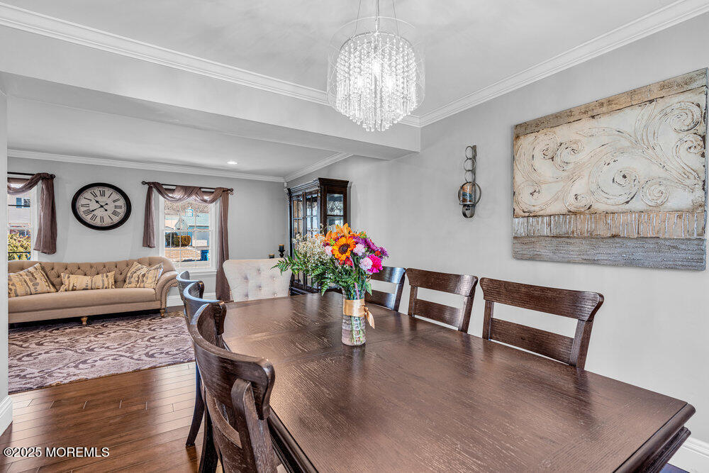 103 Starlight Road Howell, NJ 07731 - Photo 11 of 37 a living room with furniture and a chandelier