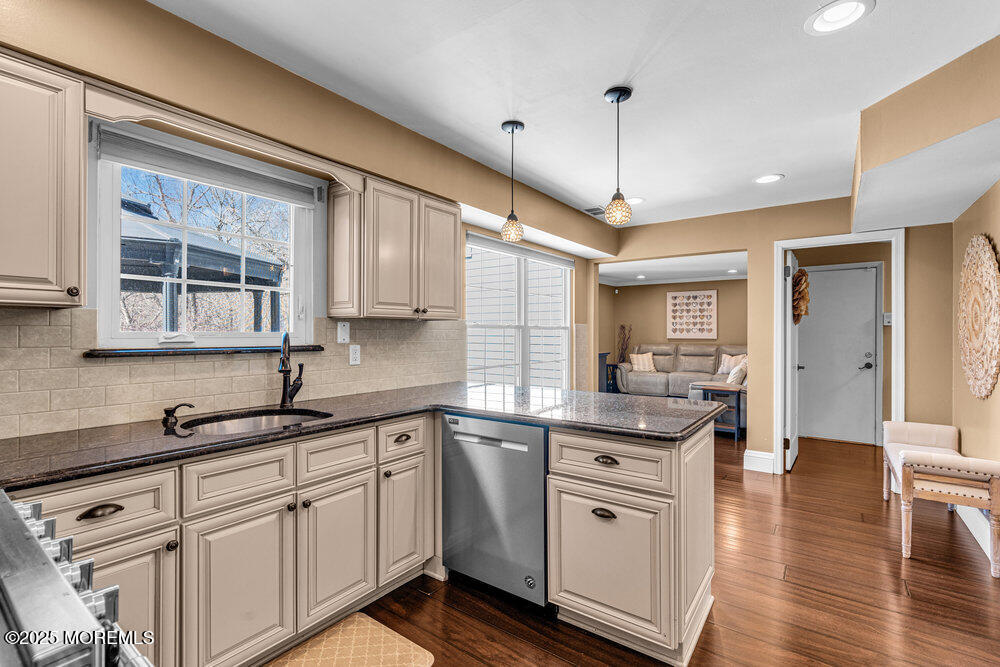 103 Starlight Road Howell, NJ 07731 - Photo 12 of 37 a kitchen with white cabinets and wooden floor