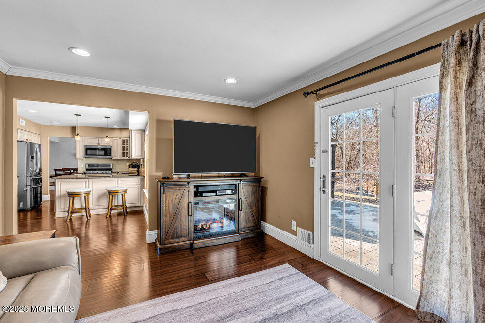 103 Starlight Road Howell, NJ 07731 - Photo 20 of 37 a living room with furniture wooden floor and a flat screen tv