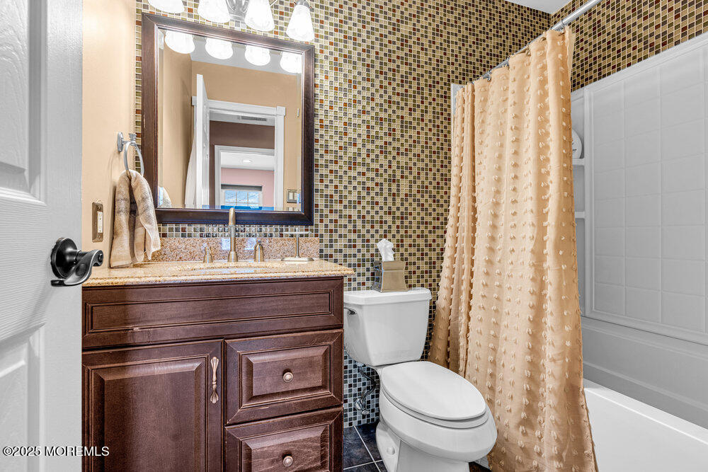 103 Starlight Road Howell, NJ 07731 - Photo 22 of 37 a bathroom with a toilet a sink and a mirror