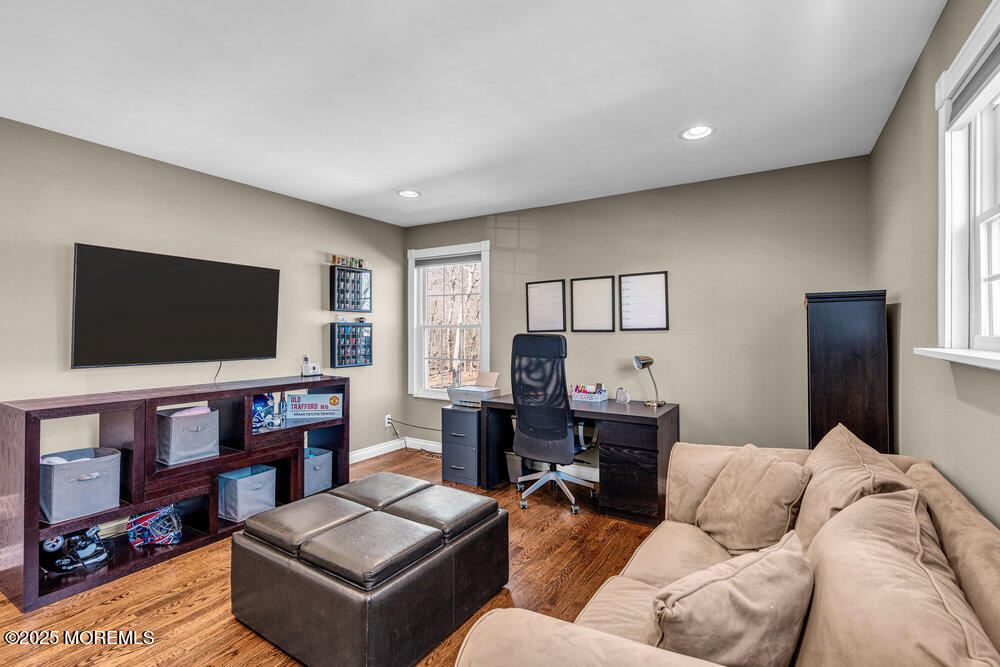 103 Starlight Road Howell, NJ 07731 - Photo 23 of 37 a living room with furniture and a flat screen tv