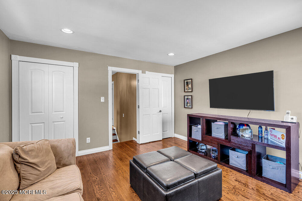 103 Starlight Road Howell, NJ 07731 - Photo 25 of 37 a living room with furniture and a flat screen tv