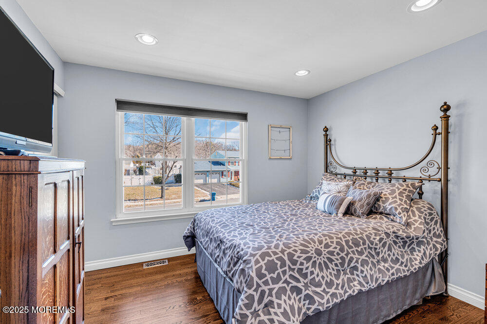 103 Starlight Road Howell, NJ 07731 - Photo 26 of 37 a bedroom with a large bed and a flat tv screen