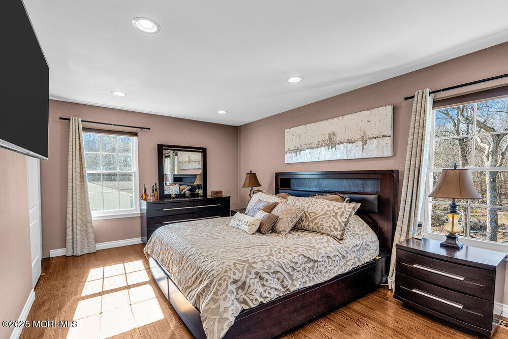 103 Starlight Road Howell, NJ 07731 - Photo 29 of 37 a bedroom with a large bed and a flat tv screen