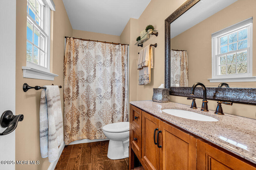 103 Starlight Road Howell, NJ 07731 - Photo 31 of 37 a bathroom with a granite countertop sink toilet and shower