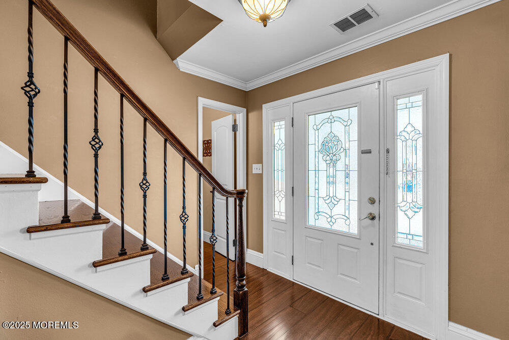 103 Starlight Road Howell, NJ 07731 - Photo 4 of 37 a view of entryway with wooden floor and stairs