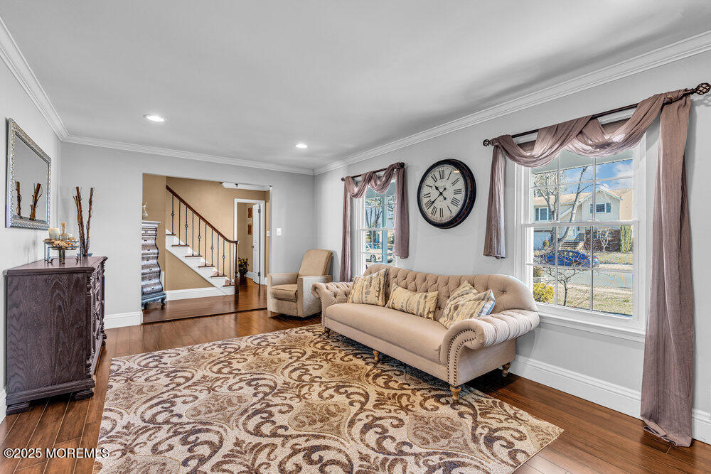 103 Starlight Road Howell, NJ 07731 - Photo 8 of 37 a living room with furniture and a clock