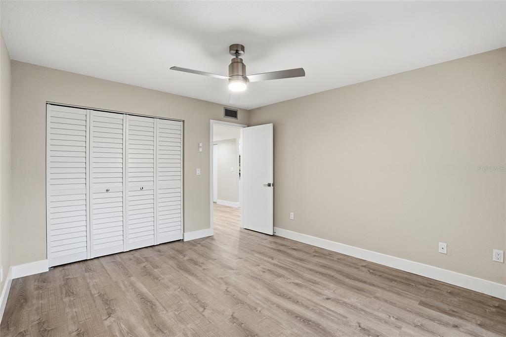 22375 Edgewater Drive, Unit 124 Punta Gorda, FL 33980 - Photo 12 of 29 an empty room with closet and a ceiling fan