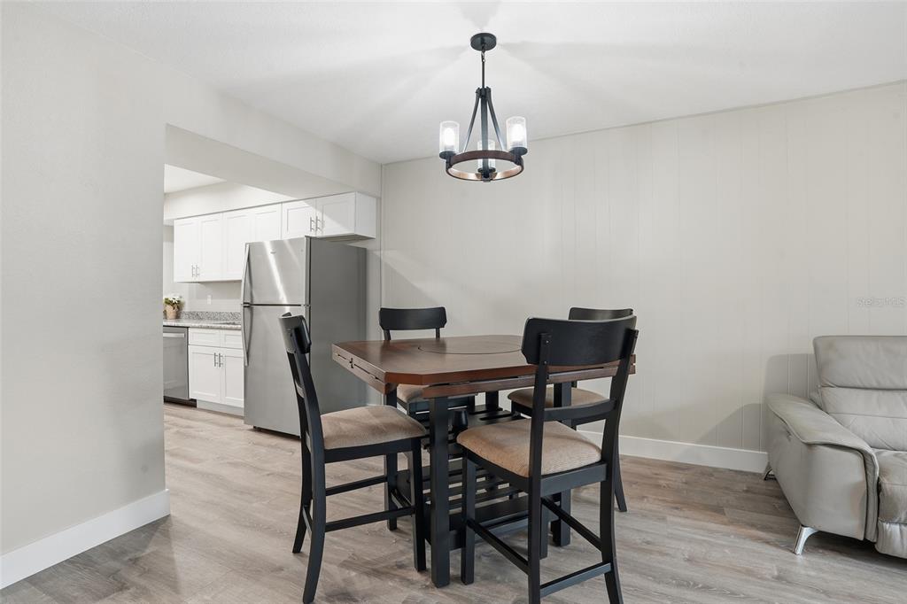 22375 Edgewater Drive, Unit 124 Punta Gorda, FL 33980 - Photo 6 of 29 a view of a dining room with furniture and wooden floor
