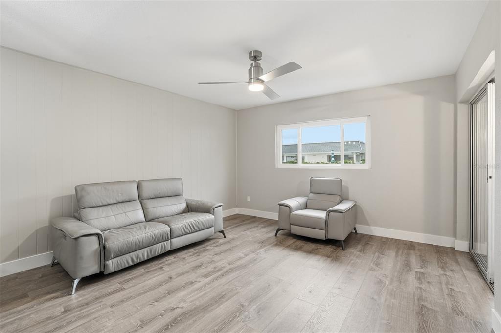 22375 Edgewater Drive, Unit 124 Punta Gorda, FL 33980 - Photo 8 of 29 a living room with furniture and a large window