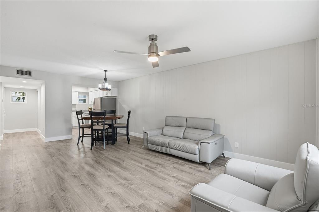 22375 Edgewater Drive, Unit 124 Punta Gorda, FL 33980 - Photo 10 of 29 a living room with furniture a dining table with kitchen view