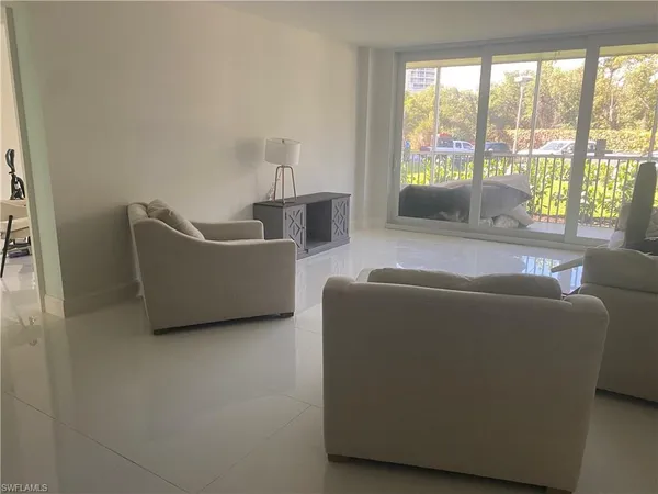 a living room with furniture and a large window