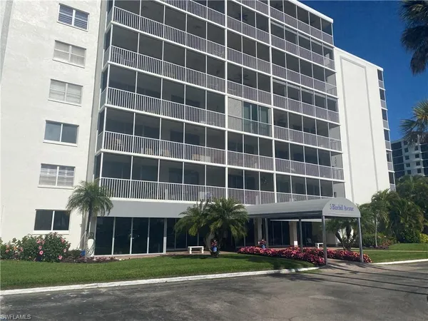 a front view of a building with a garden