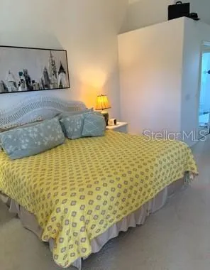 a bed sitting in a bedroom next to a wall