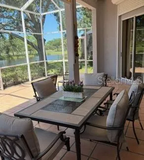 a view of a balcony with table and chairs and wooden floor