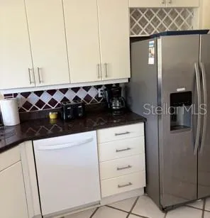 a kitchen with a refrigerator and cabinets